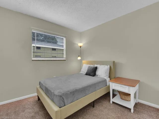 Bedroom featuring a textured ceiling and carpet flooring