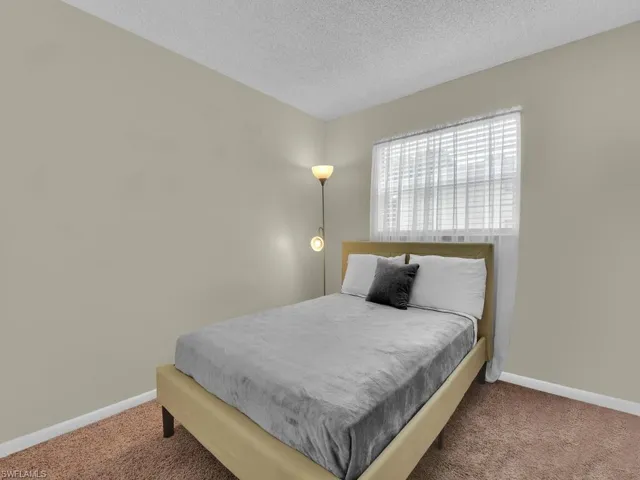 Bedroom featuring a textured ceiling and carpet flooring