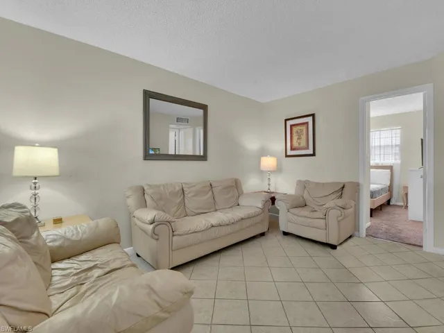 Living room featuring light carpet and a textured ceiling