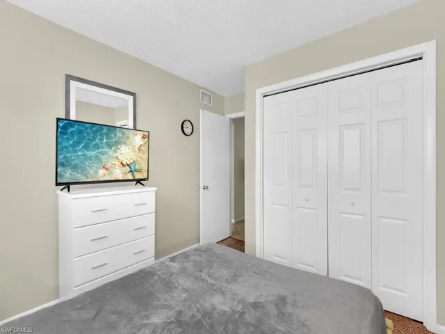 Unfurnished bedroom with a closet, a textured ceiling, and carpet floors