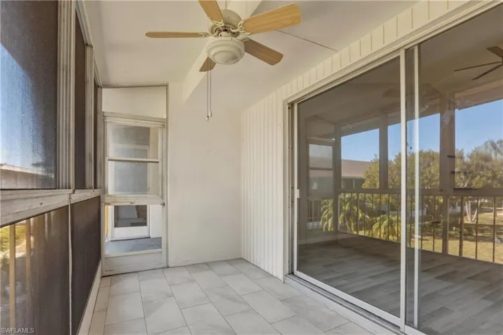 Unfurnished sunroom with a ceiling fan and plenty of natural light