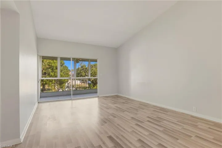 Empty room with light wood-style flooring and baseboards