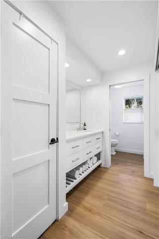 Ensuite primary bathroom has marble countertop.