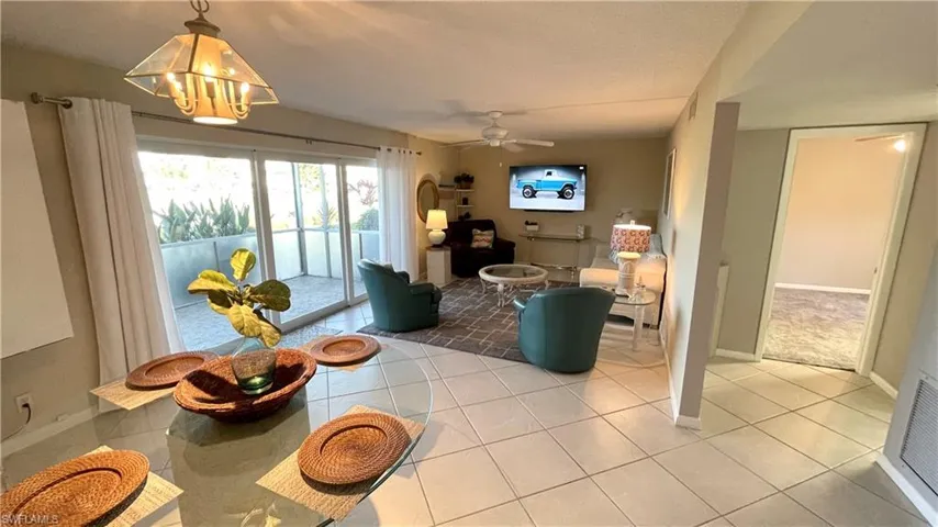 Living area with baseboards and light tile patterned floors