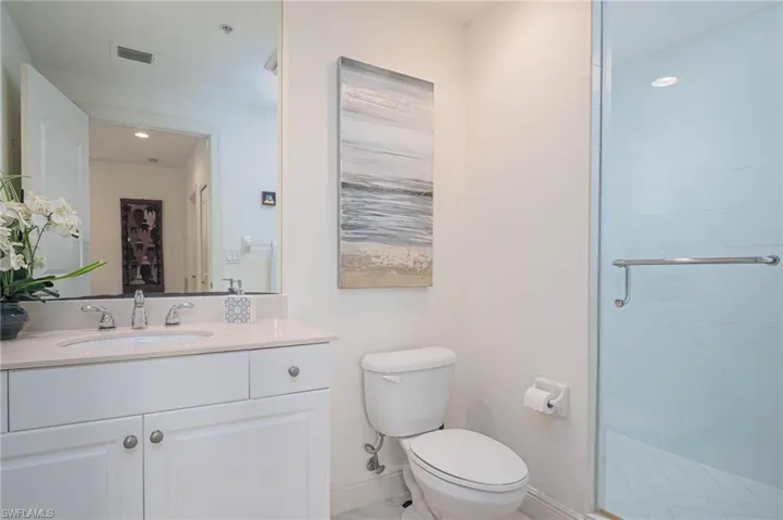 Bathroom with vanity, a stall shower, and recessed lighting