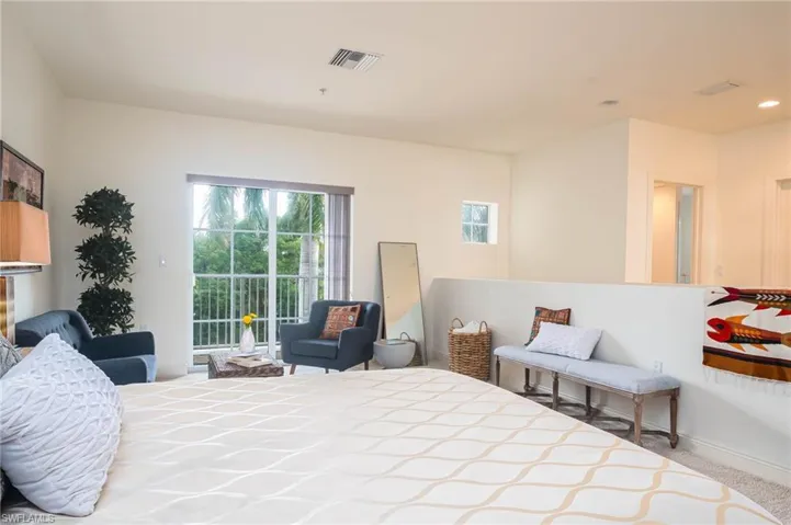 Carpeted bedroom featuring access to outside and baseboards