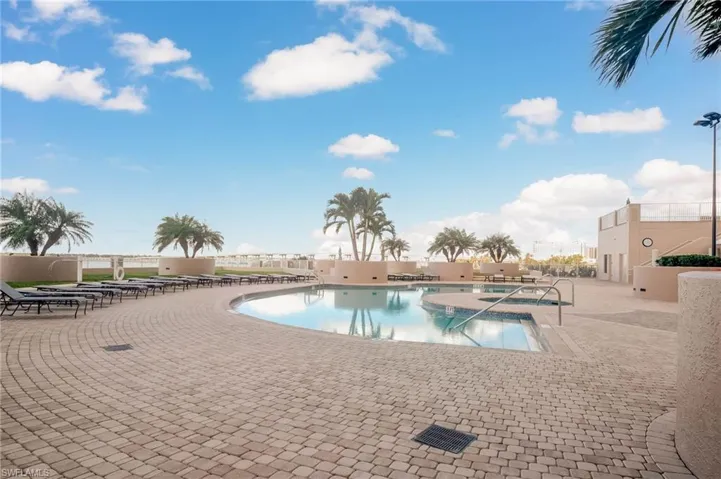 Community pool with a patio area and a jacuzzi