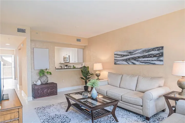 Living area with light tile patterned flooring and baseboards