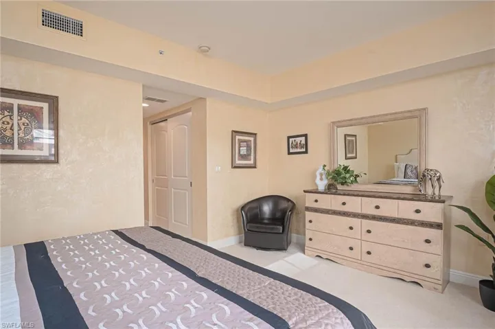 Bedroom with light colored carpet