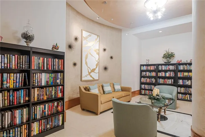 Sitting room with wall of books and recessed lighting