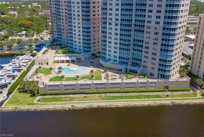 Bird's eye view of a nearby body of water and a pool area