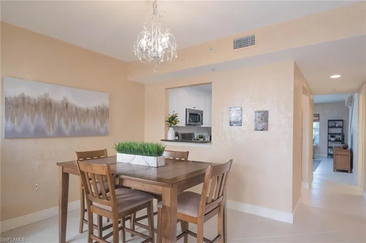 Dining room featuring light tile patterned floors, a chandelier, and recessed lighting