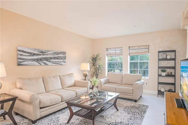 Living area featuring light tile patterned floors and baseboards