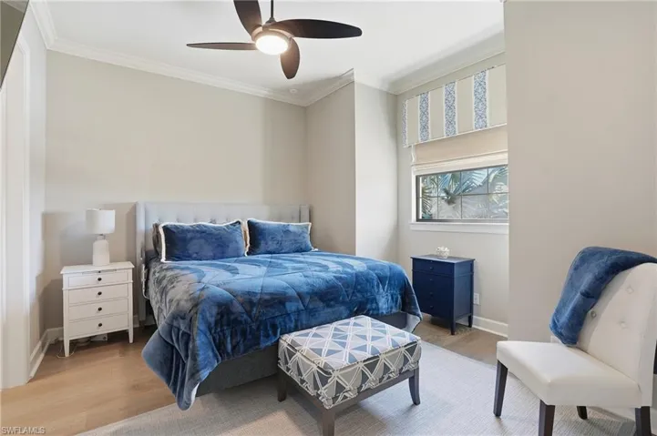 Bedroom featuring crown molding, wood finished floors, and ceiling fan