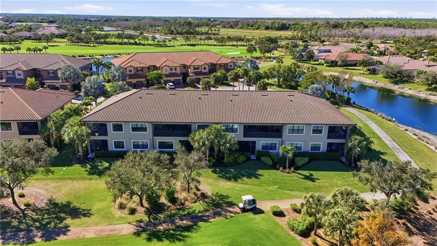 Drone / aerial view of a large body of water and a golf course
