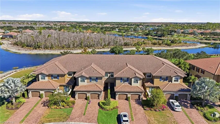 Aerial view of residential area featuring a nearby body of water