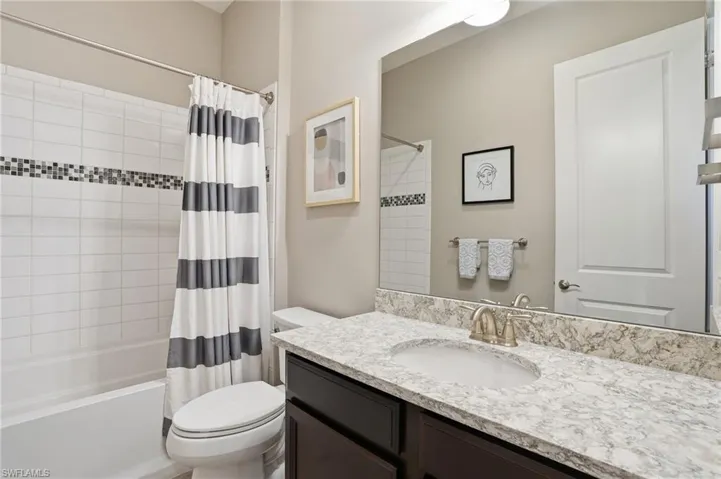 Full bathroom featuring shower / tub combo and vanity