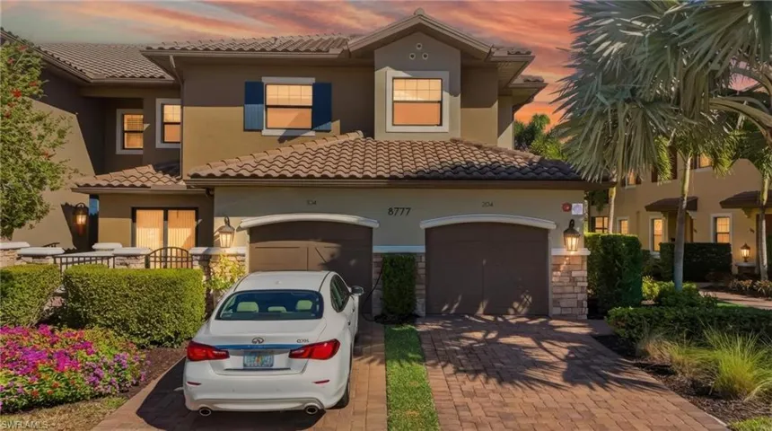 Mediterranean / spanish-style home with decorative driveway, stucco siding, a garage, and a tile roof