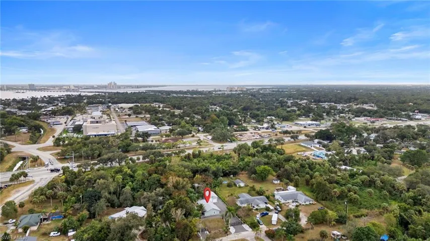 View of property location featuring a tree filled landscape