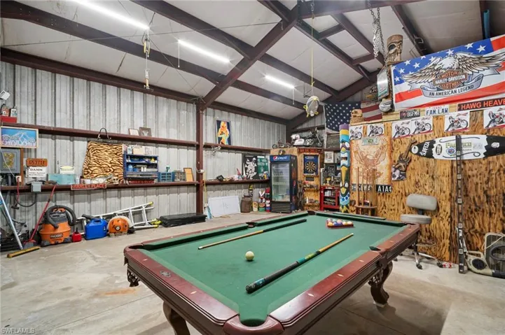 Game room featuring billiards table, metal wall, and concrete floors