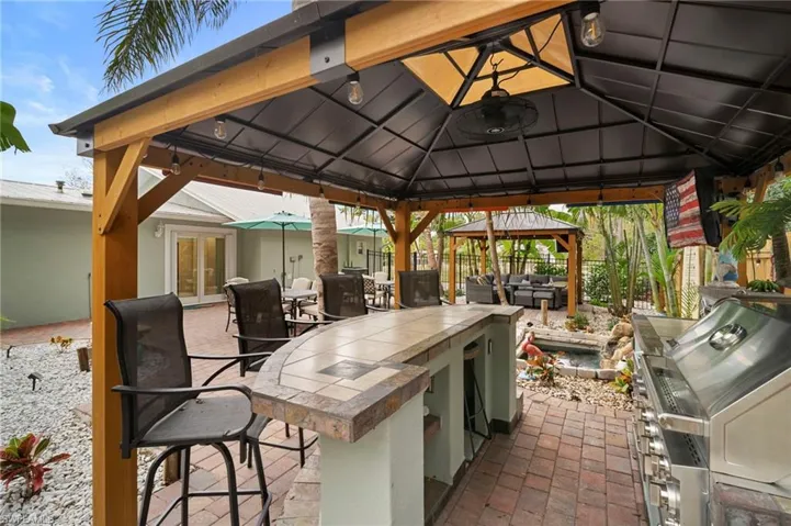 View of patio with a gazebo, area for grilling, and french doors