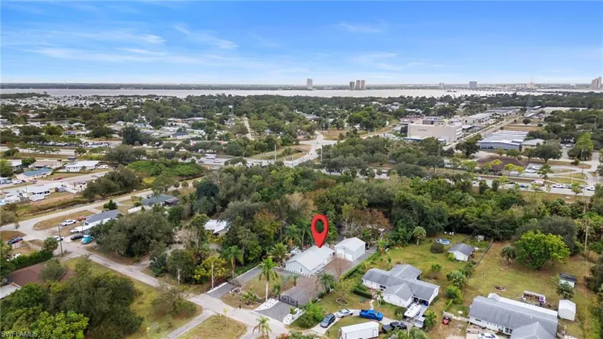 Aerial view of property's location with nearby suburban area