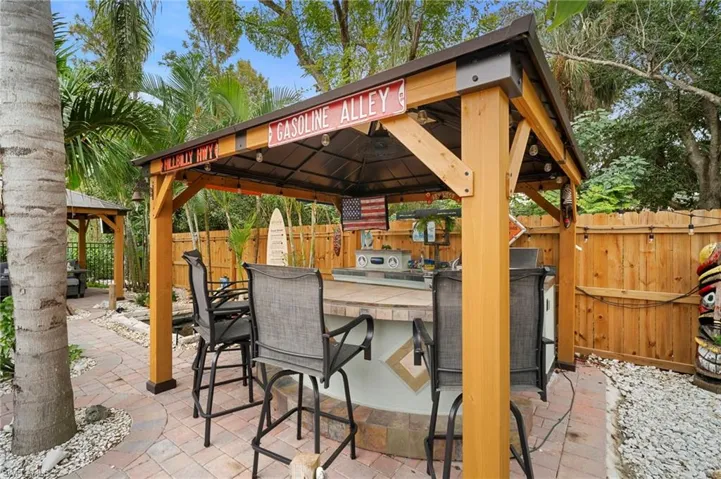 Fenced backyard featuring a gazebo and a patio area