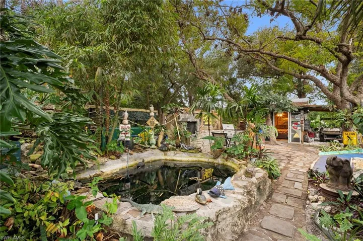 View of pool featuring a garden pond