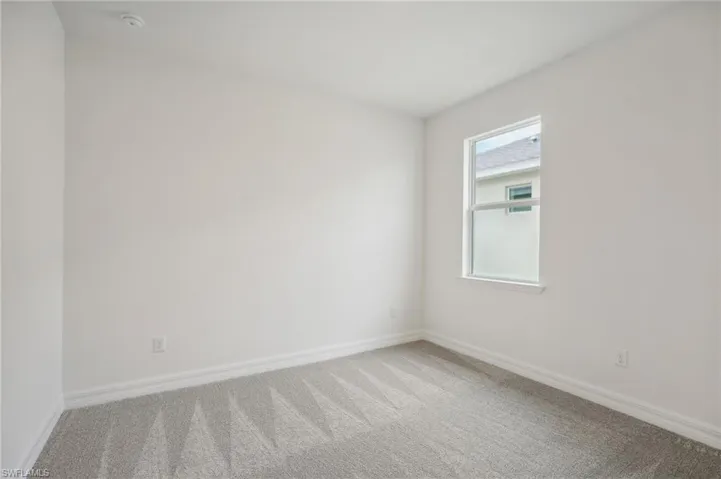 Spare room featuring carpet flooring