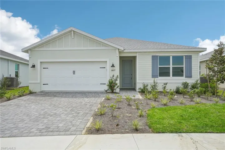 Ranch-style house with central AC unit and a garage
