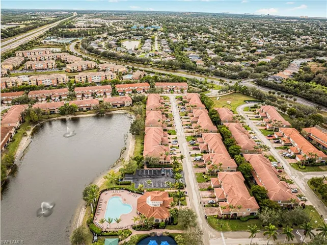 Birds eye view of property with a water view