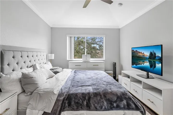 Bedroom featuring crown molding, ceiling fan, and lofted ceiling