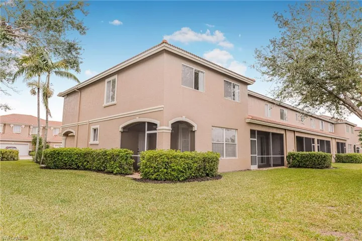 Rear view of house featuring a yard
