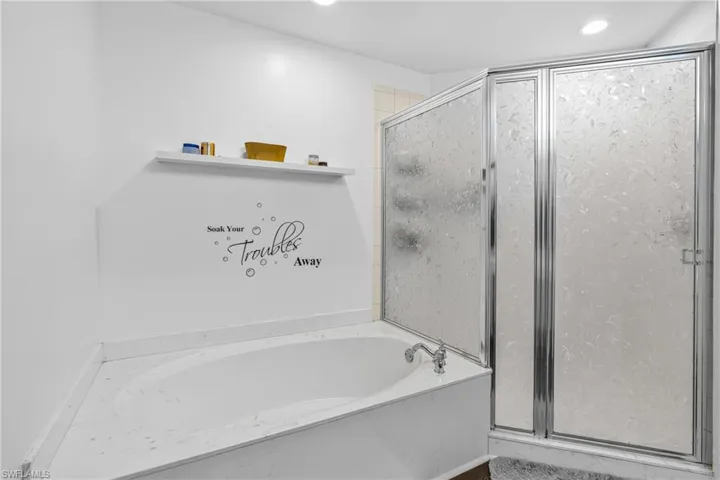 Bathroom featuring independent shower and bath