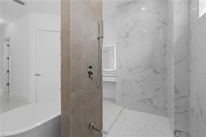 Primary bathroom with a freestanding bath and walk in shower