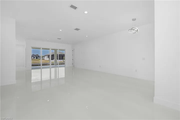 Living room with recessed lighting and sliding glass doors to patio
