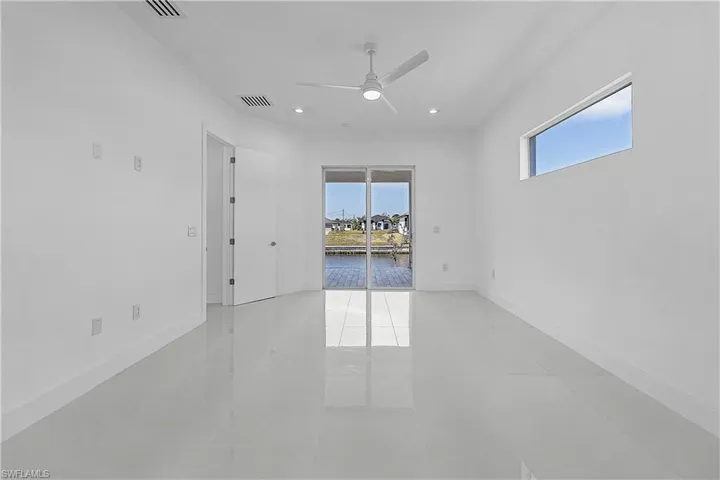 Primary bedroom with baseboards, ceiling fan, and light tile patterned floors