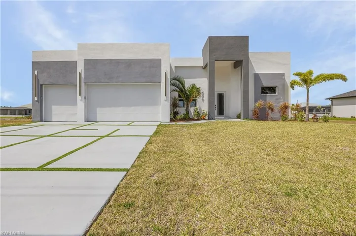Contemporary home featuring stucco siding, an attached three car garage, a front lawn, and concrete driveway