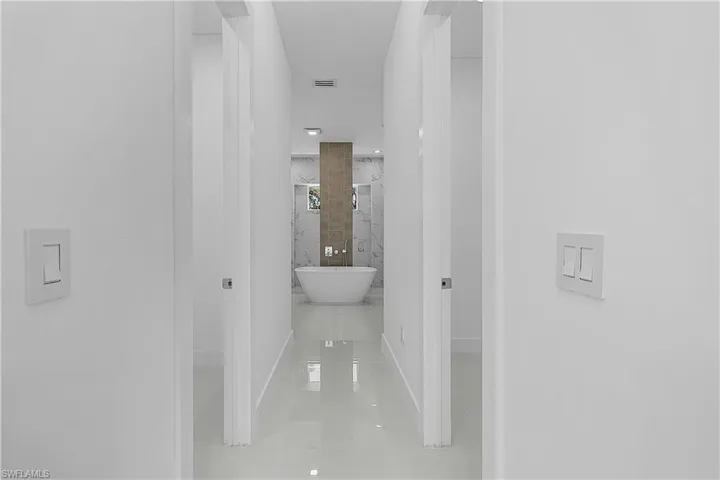 Primary Suite Hall featuring primary suite and tile patterned flooring