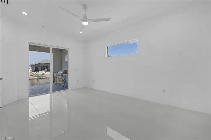 Primary bedroom featuring tile patterned floors, recessed lighting, and a ceiling fan
