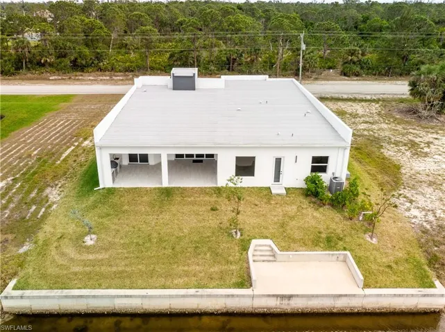 Birds eye view of property featuring a water view from the back