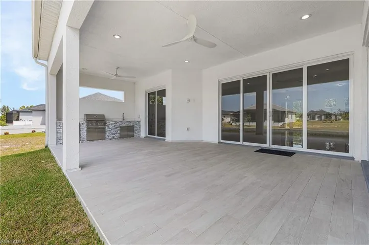 View of patio with ceiling fans, an outdoor kitchen, and area for grilling