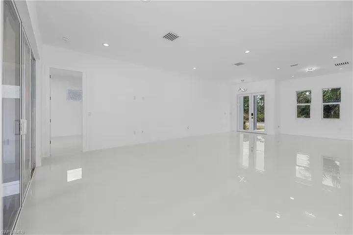 Living room with recessed lighting and white tile patterned floors