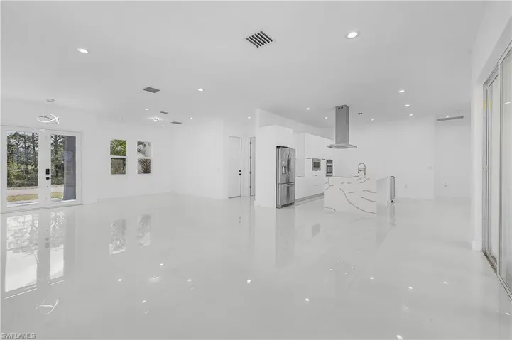 Living featuring french doors, recessed lighting, and a view of the kitchen