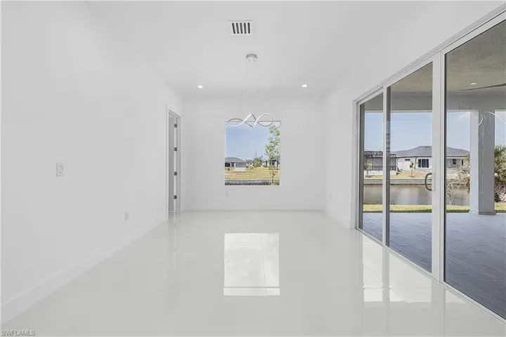 Dining room featuring a water view, recessed lighting, and an inviting chandelier