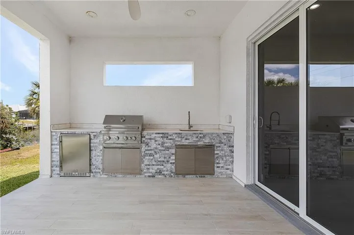 View of patio featuring an outdoor kitchen