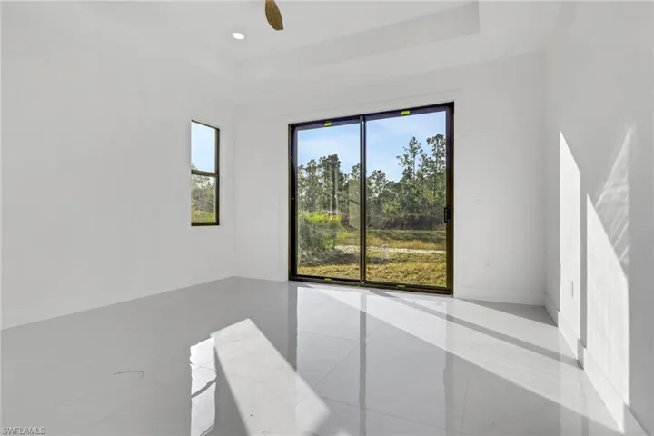 Unfurnished room with a ceiling fan, recessed lighting, and a raised ceiling