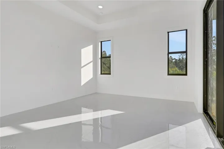 Empty room featuring recessed lighting and light marble finish floors
