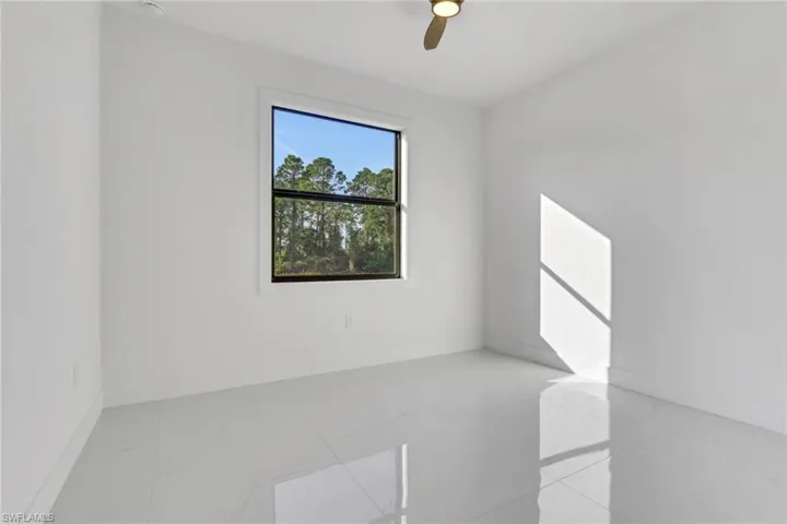 Unfurnished room featuring baseboards and a ceiling fan