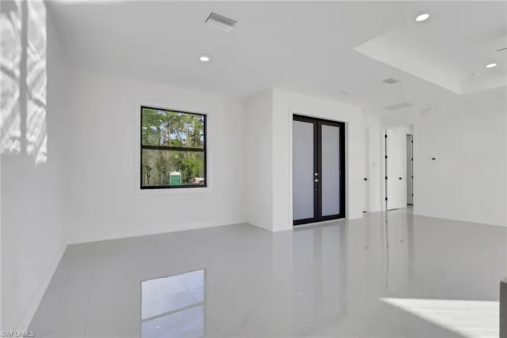 Empty room with recessed lighting and french doors